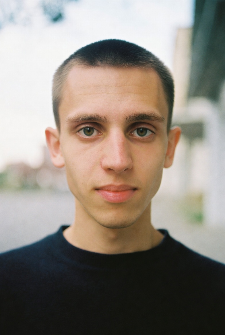 Portrait of a young man in a racing suit.